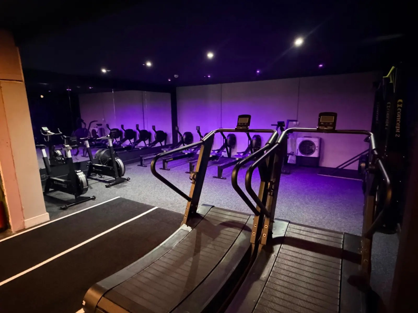 Concept 2 rowers, air bikes and curved treadmills in the conditioning studio