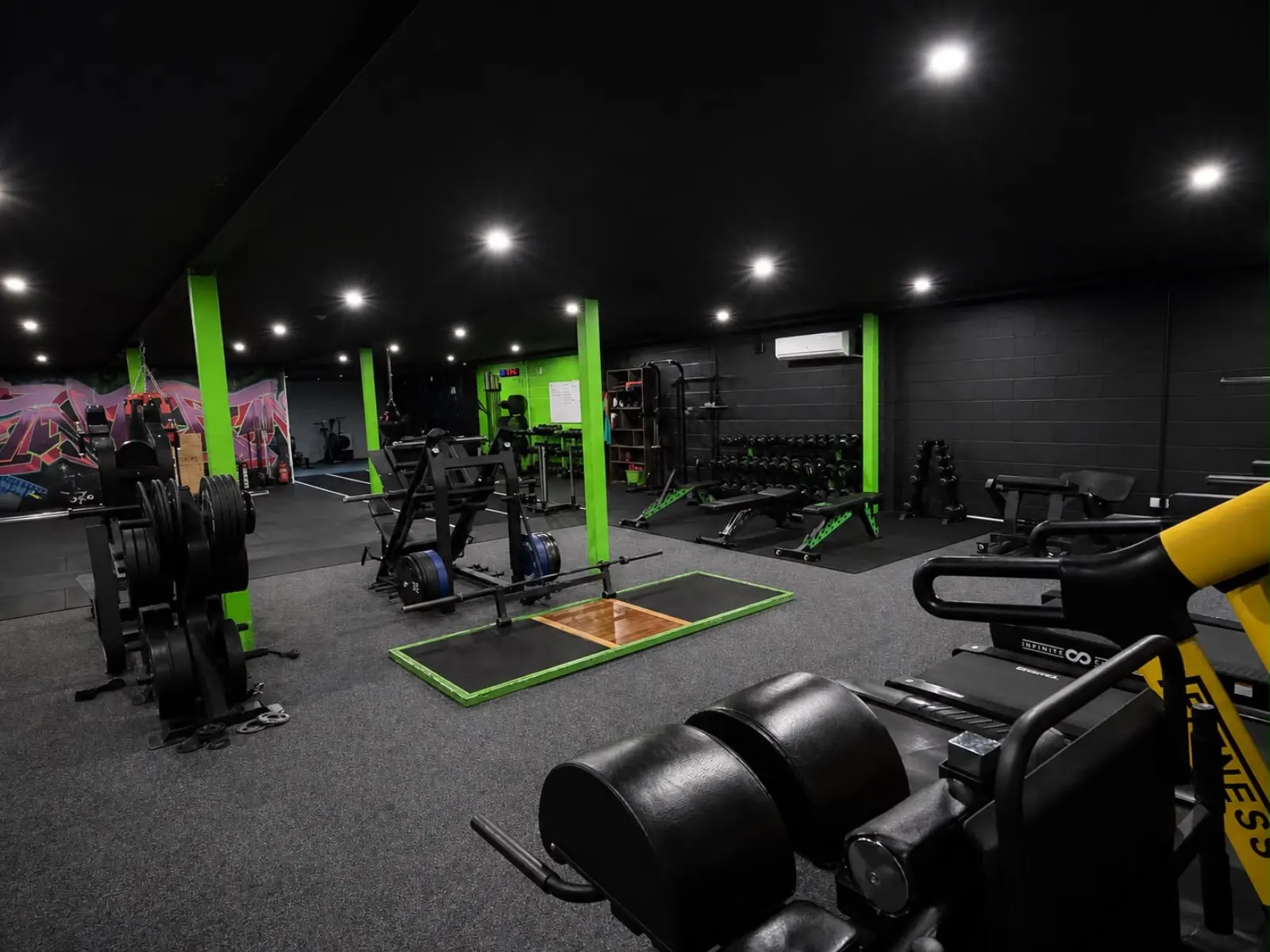 Strength and conditioning floor with squat racks and Olympic lifting platform